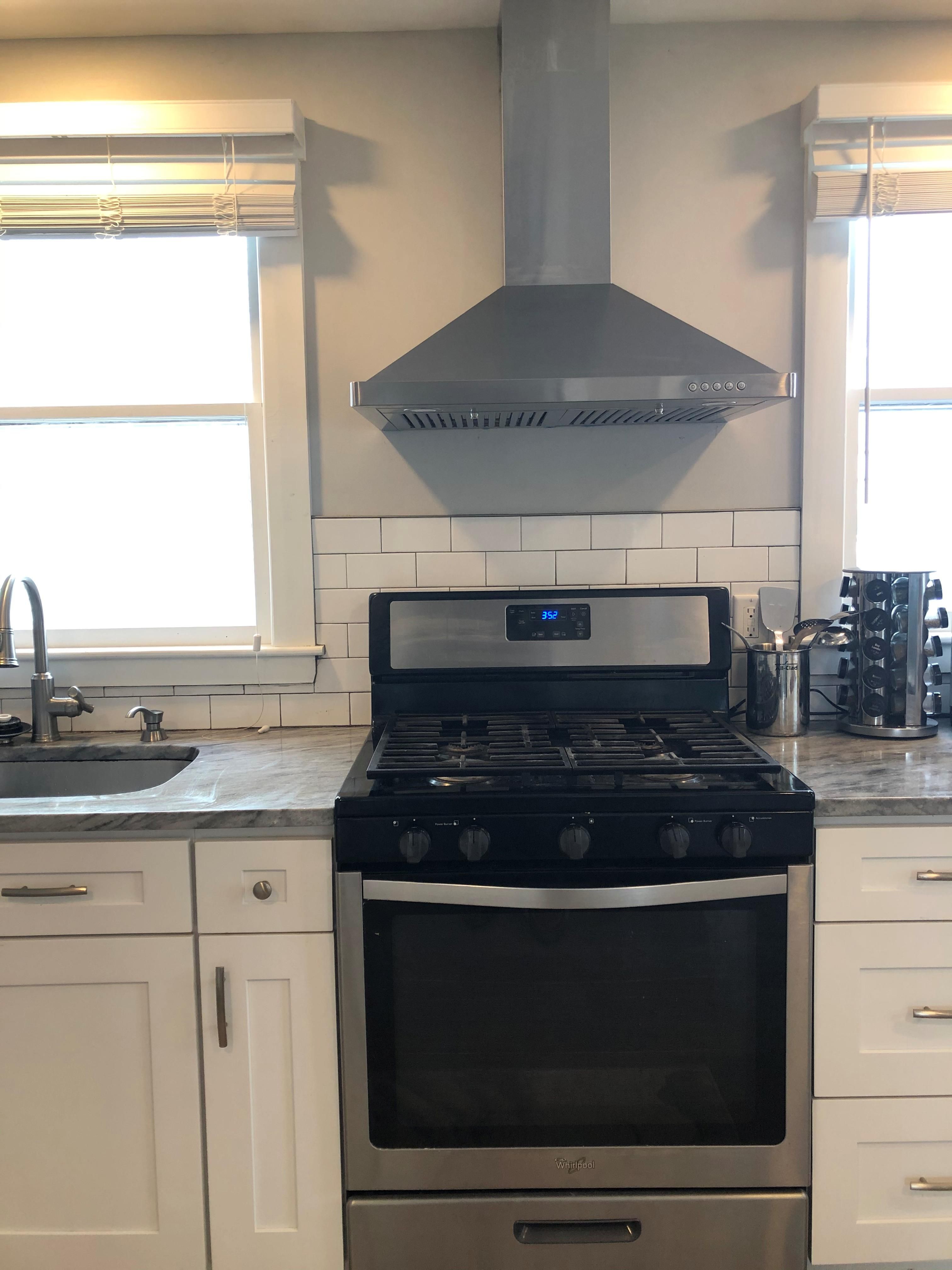 Ducted range hood over stove in kitchen
